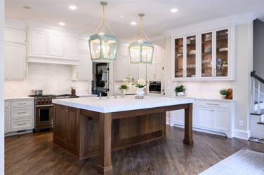 Two-tone white kitchen with walnut Buckskin-stained island and marble counters in Raleigh, NC
