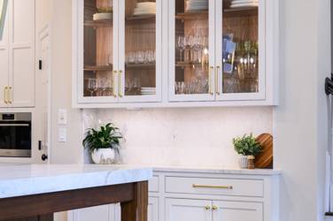 Two-tone white kitchen with walnut Buckskin-stained island and marble counters in Raleigh, NC