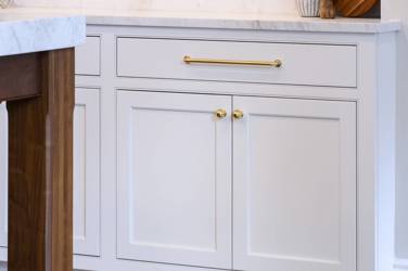 Two-tone white kitchen with walnut Buckskin-stained island and marble counters in Raleigh, NC