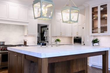 Two-tone white kitchen with walnut Buckskin-stained island and marble counters in Raleigh, NC