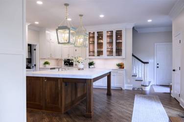 Two-tone white kitchen with walnut Buckskin-stained island and marble counters in Raleigh, NC