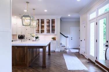 Two-tone white kitchen with walnut Buckskin-stained island and marble counters in Raleigh, NC