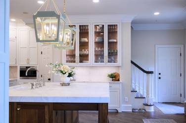 Two-tone white kitchen with walnut Buckskin-stained island and marble counters in Raleigh, NC