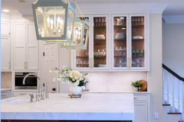 Two-tone white kitchen with walnut Buckskin-stained island and marble counters in Raleigh, NC