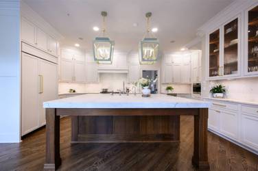 Two-tone white kitchen with walnut Buckskin-stained island and marble counters in Raleigh, NC