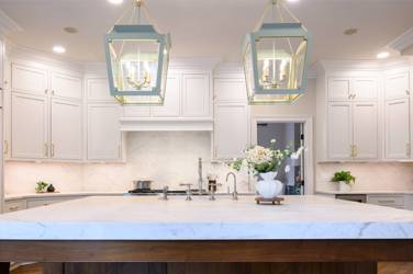 Two-tone white kitchen with walnut Buckskin-stained island and marble counters in Raleigh, NC
