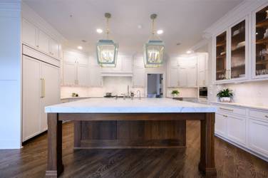 Two-tone white kitchen with walnut Buckskin-stained island and marble counters in Raleigh, NC