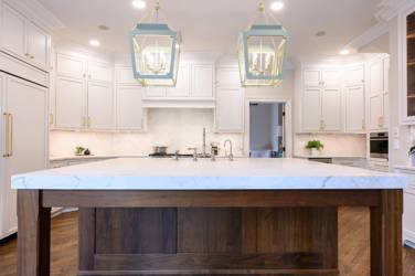 Two-tone white kitchen with walnut Buckskin-stained island and marble counters in Raleigh, NC