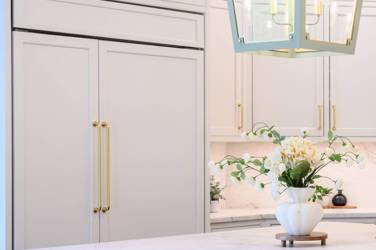 Two-tone white kitchen with walnut Buckskin-stained island and marble counters in Raleigh, NC