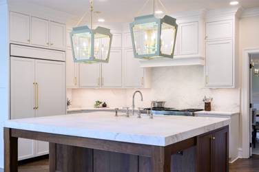 Two-tone white kitchen with walnut Buckskin-stained island and marble counters in Raleigh, NC