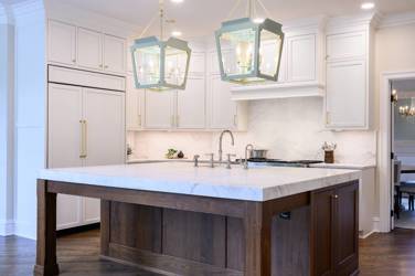 Two-tone white kitchen with walnut Buckskin-stained island and marble counters in Raleigh, NC