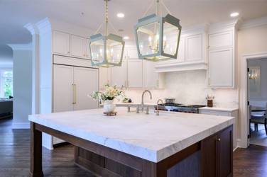 Two-tone white kitchen with walnut Buckskin-stained island and marble counters in Raleigh, NC