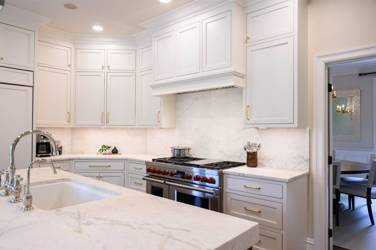 Two-tone white kitchen with walnut Buckskin-stained island and marble counters in Raleigh, NC