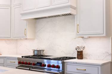 Two-tone white kitchen with walnut Buckskin-stained island and marble counters in Raleigh, NC