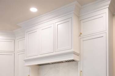 Two-tone white kitchen with walnut Buckskin-stained island and marble counters in Raleigh, NC