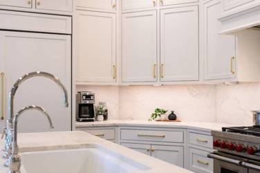 Two-tone white kitchen with walnut Buckskin-stained island and marble counters in Raleigh, NC