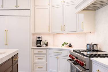 Two-tone white kitchen with walnut Buckskin-stained island and marble counters in Raleigh, NC