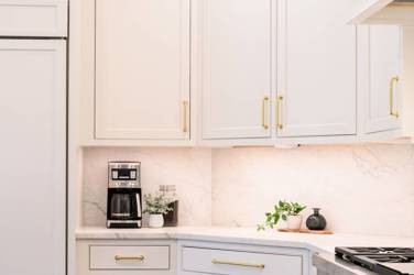 Two-tone white kitchen with walnut Buckskin-stained island and marble counters in Raleigh, NC