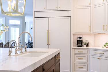 Two-tone white kitchen with walnut Buckskin-stained island and marble counters in Raleigh, NC