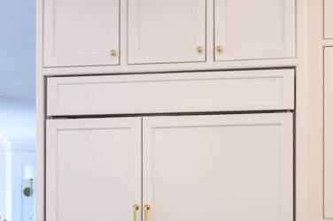 Two-tone white kitchen with walnut Buckskin-stained island and marble counters in Raleigh, NC