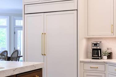 Two-tone white kitchen with walnut Buckskin-stained island and marble counters in Raleigh, NC