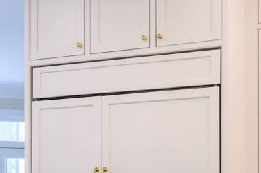 Two-tone white kitchen with walnut Buckskin-stained island and marble counters in Raleigh, NC