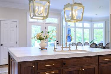Two-tone white kitchen with walnut Buckskin-stained island and marble counters in Raleigh, NC