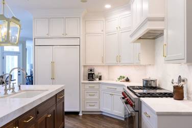 Two-tone white kitchen with walnut Buckskin-stained island and marble counters in Raleigh, NC