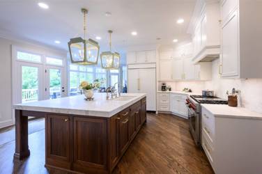 Two-tone white kitchen with walnut Buckskin-stained island and marble counters in Raleigh, NC