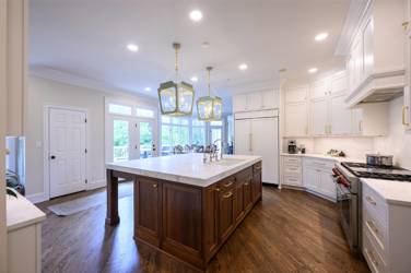 Two-tone white kitchen with walnut Buckskin-stained island and marble counters in Raleigh, NC