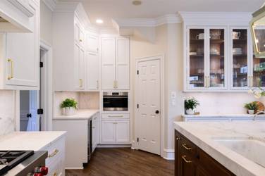 Two-tone white kitchen with walnut Buckskin-stained island and marble counters in Raleigh, NC