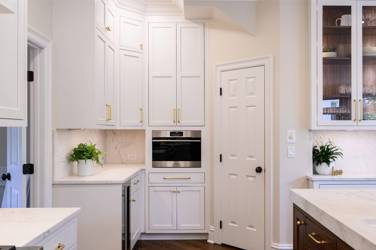 Two-tone white kitchen with walnut Buckskin-stained island and marble counters in Raleigh, NC