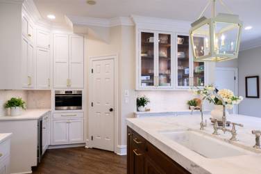 Two-tone white kitchen with walnut Buckskin-stained island and marble counters in Raleigh, NC