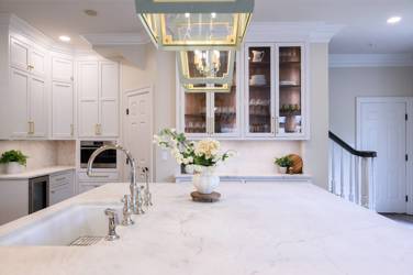 Two-tone white kitchen with walnut Buckskin-stained island and marble counters in Raleigh, NC