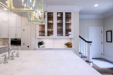 Two-tone white kitchen with walnut Buckskin-stained island and marble counters in Raleigh, NC