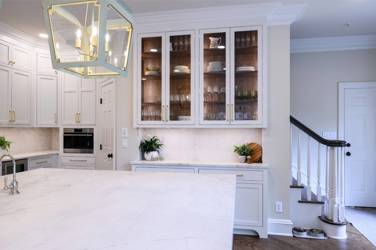 Two-tone white kitchen with walnut Buckskin-stained island and marble counters in Raleigh, NC