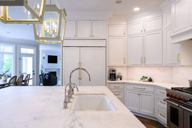 Two-tone white kitchen with walnut Buckskin-stained island and marble counters in Raleigh, NC