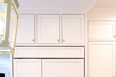 Two-tone white kitchen with walnut Buckskin-stained island and marble counters in Raleigh, NC