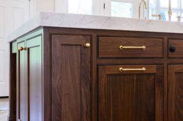 Two-tone white kitchen with walnut Buckskin-stained island and marble counters in Raleigh, NC
