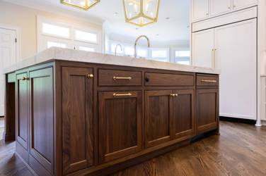 Two-tone white kitchen with walnut Buckskin-stained island and marble counters in Raleigh, NC