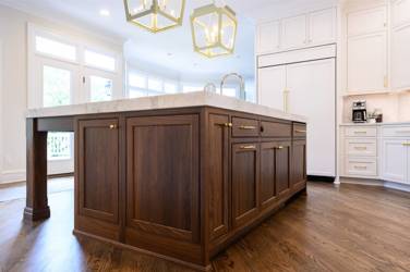 Two-tone white kitchen with walnut Buckskin-stained island and marble counters in Raleigh, NC
