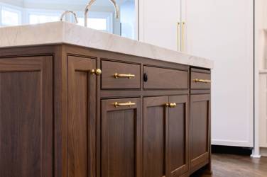 Two-tone white kitchen with walnut Buckskin-stained island and marble counters in Raleigh, NC