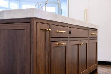 Two-tone white kitchen with walnut Buckskin-stained island and marble counters in Raleigh, NC