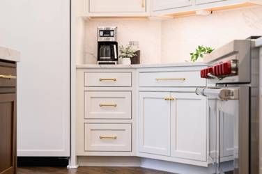Two-tone white kitchen with walnut Buckskin-stained island and marble counters in Raleigh, NC