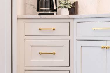 Two-tone white kitchen with walnut Buckskin-stained island and marble counters in Raleigh, NC