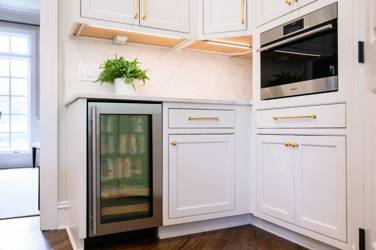 Two-tone white kitchen with walnut Buckskin-stained island and marble counters in Raleigh, NC