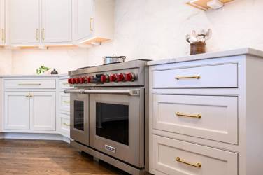 Two-tone white kitchen with walnut Buckskin-stained island and marble counters in Raleigh, NC
