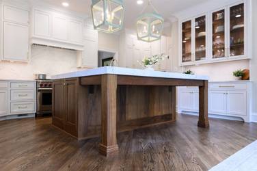 Two-tone white kitchen with walnut Buckskin-stained island and marble counters in Raleigh, NC