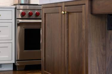 Two-tone white kitchen with walnut Buckskin-stained island and marble counters in Raleigh, NC