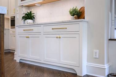 Two-tone white kitchen with walnut Buckskin-stained island and marble counters in Raleigh, NC